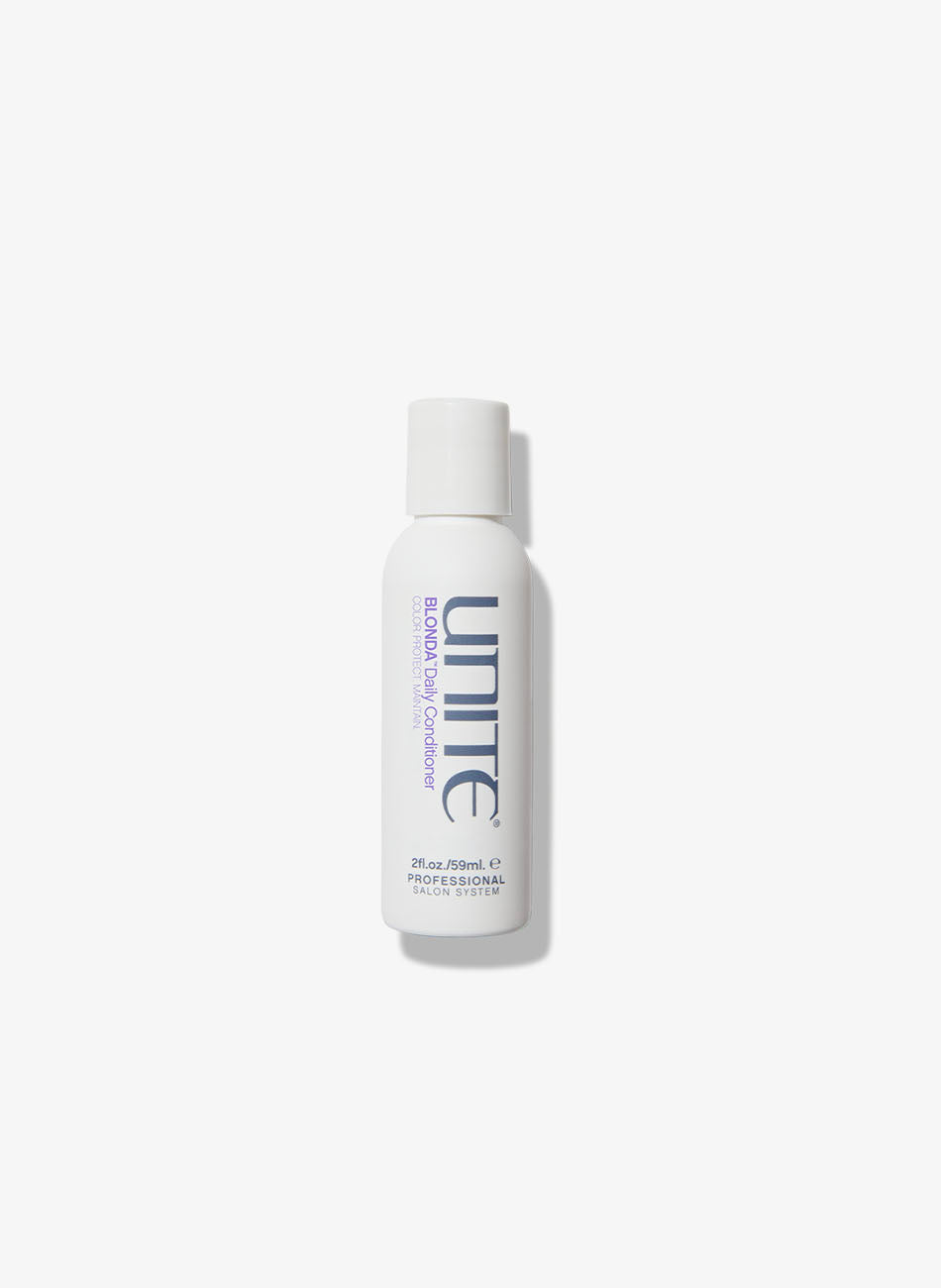 Travel-size bottle of purple conditioner for professional salon use.