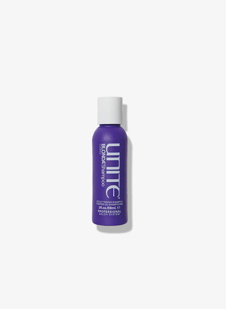 Travel-size bottle of violet shampoo for salon hair care.