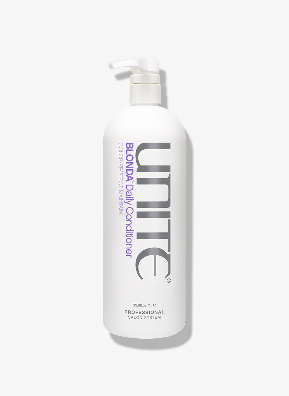 Bottle of purple conditioner with pump dispenser for color protection and maintenance.