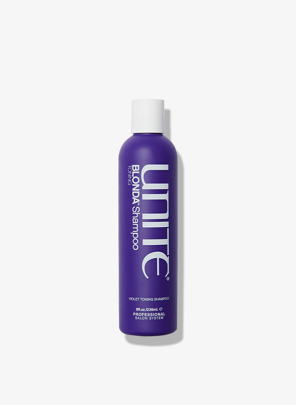 Bottle of violet shampoo for blonde hair care.