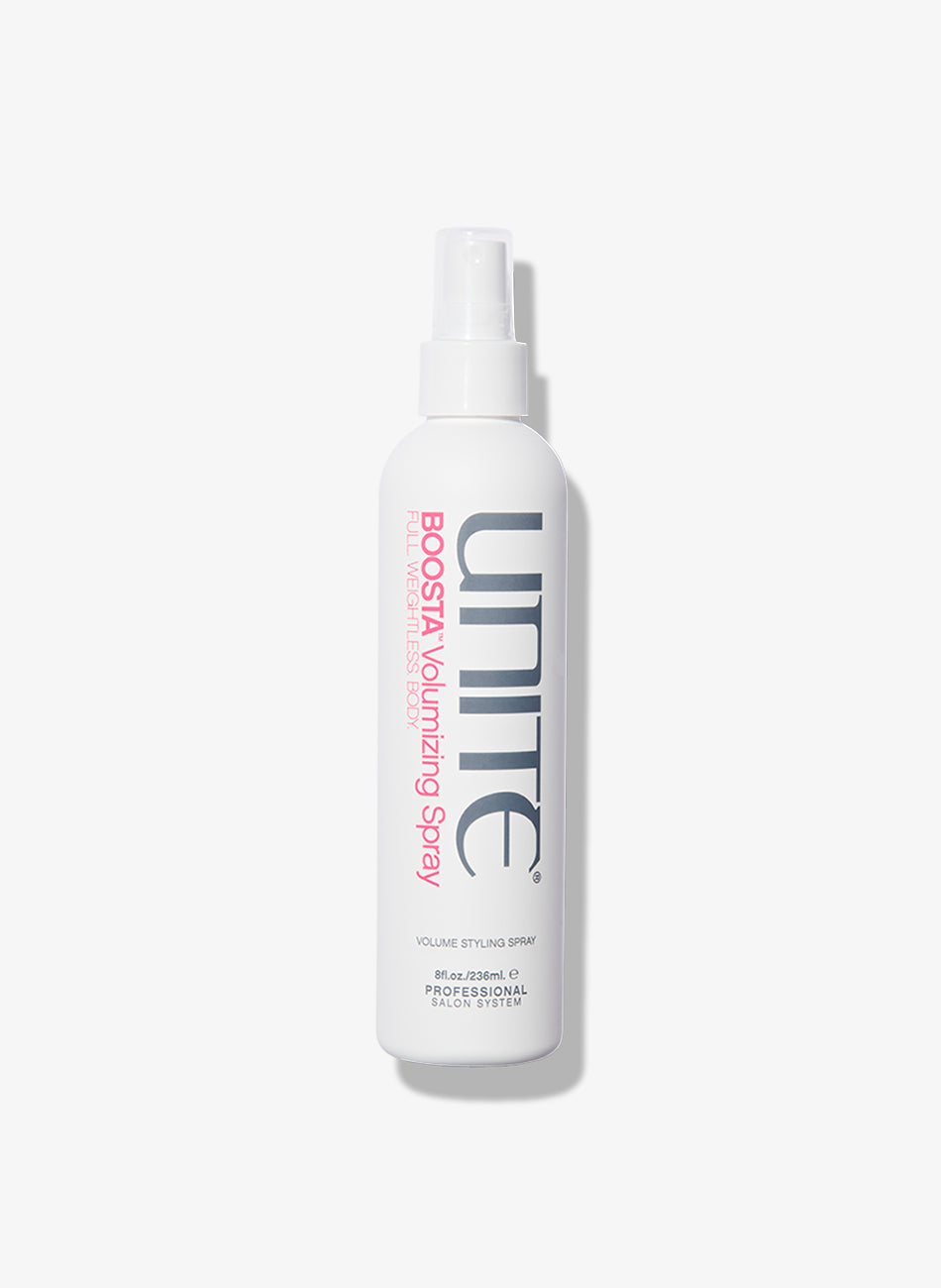 Bottle of volumizing spray for professional salon hair styling.